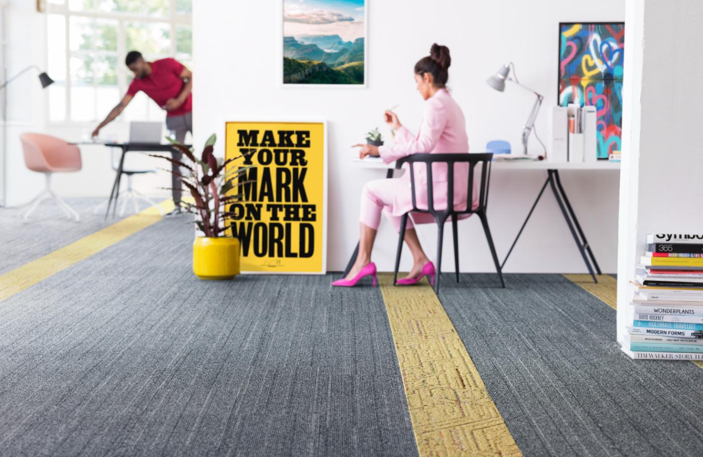 Office with professional women looking at yellow sign